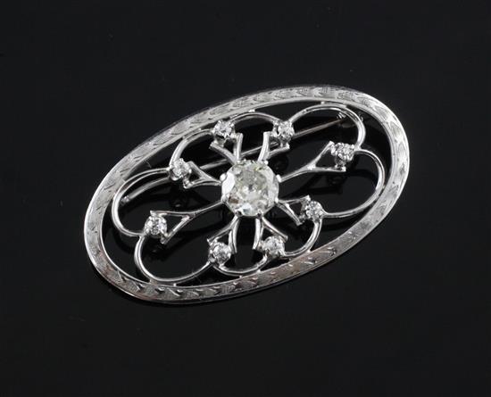 A white gold and diamond oval open work brooch, 1.75in.